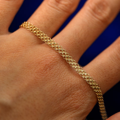 A yellow gold Bismark Chain Bracelet on the back of a model's hand to show the details of the links