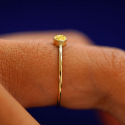 Side view of a solid gold Yellow Diamond Ring on a model's finger