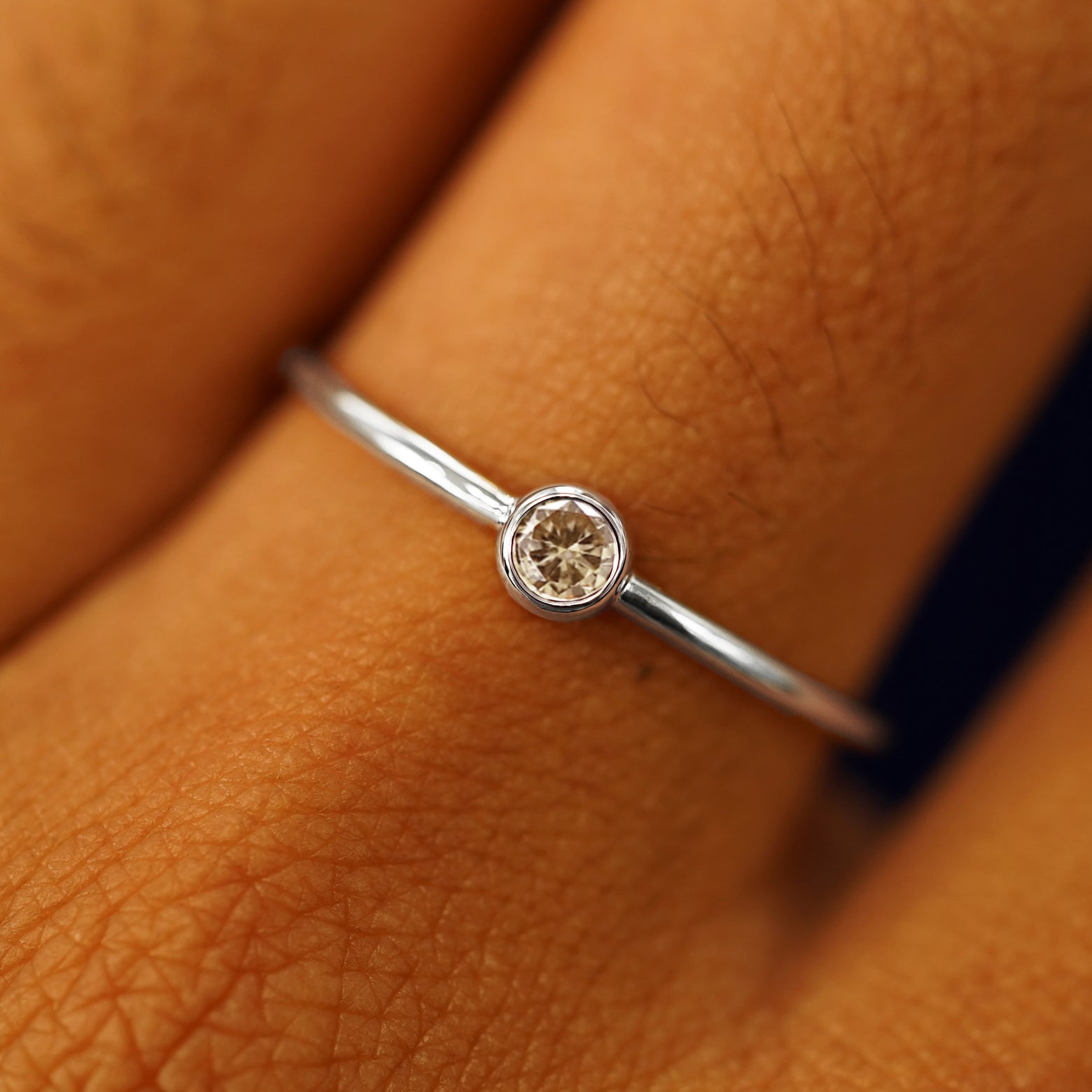 Close up view of a model's fingers wearing a platinum Champagne Diamond Ring