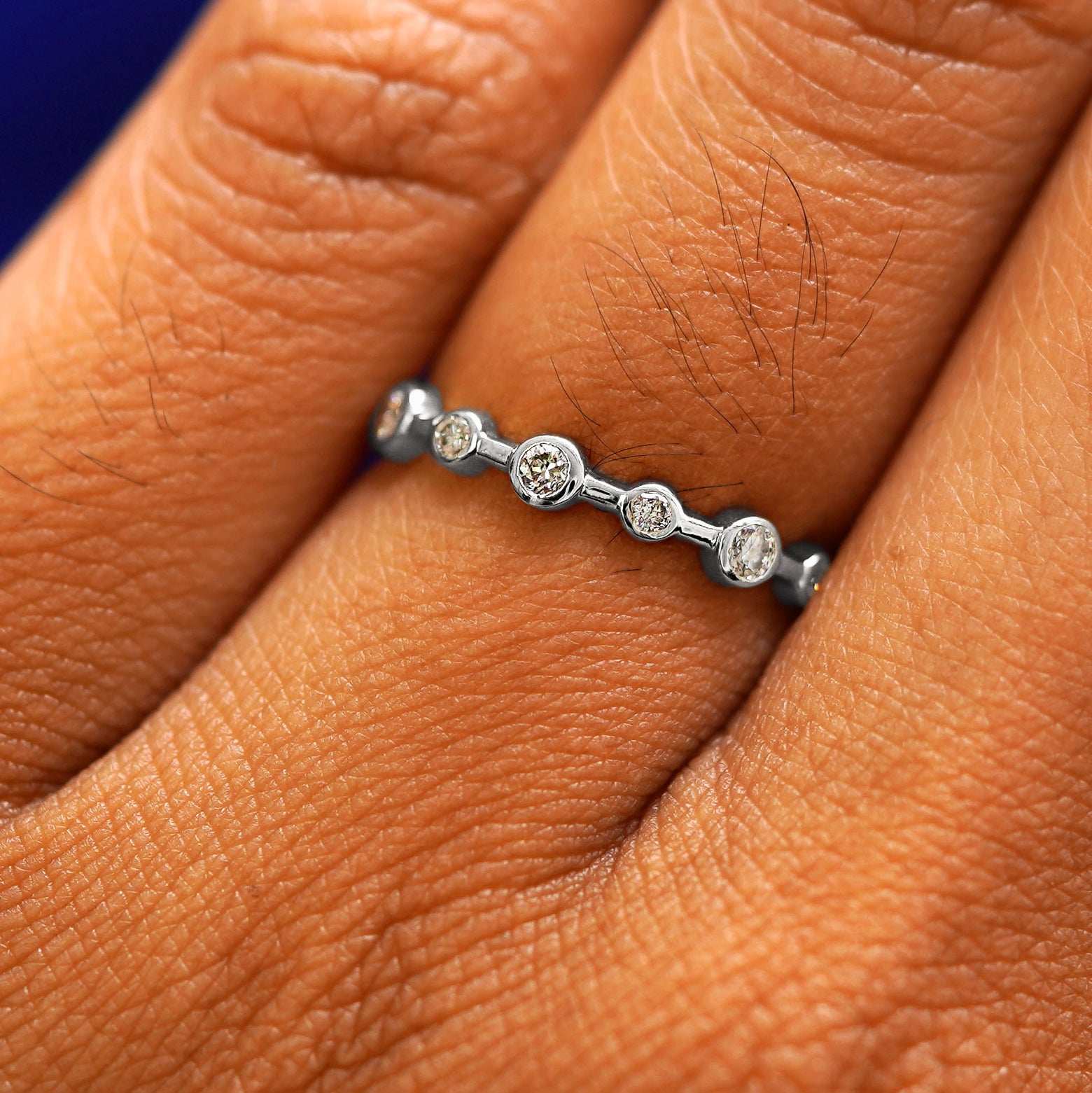 Close up view of a model's fingers wearing a 950 platinum Infinity Diamond Ring