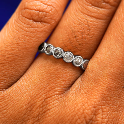 Close up view of a model's hand wearing a 950 platinum Milgrain Diamond Band