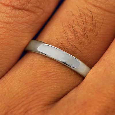Close up view of a model's fingers wearing a Platinum Mix Mirror Band