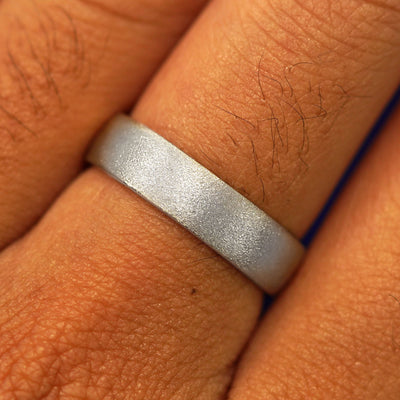 Close up view of a model's fingers wearing a Platinum Mix Stardust Band
