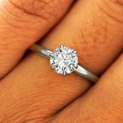 Close up view of a model's fingers wearing a 950 platinum Round Lab Diamond Ring