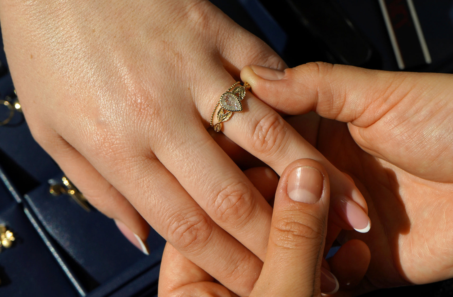 Close up view of a couples hands choosing their engagement ring