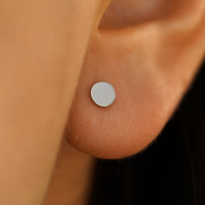 Close up view of a model's ear wearing a white gold Large Circle Earring