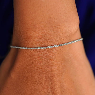 A model's wrist wearing a solid 14k white gold Rope Bracelet