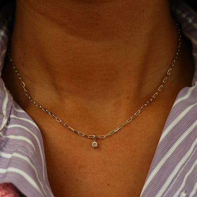 Close up view of a model's neck wearing a yellow gold Champagne Diamond Charm on a Butch Chain