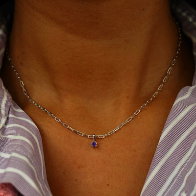 Close up view of a model's neck wearing a champagne gold Amethyst Charm on a Butch Chain