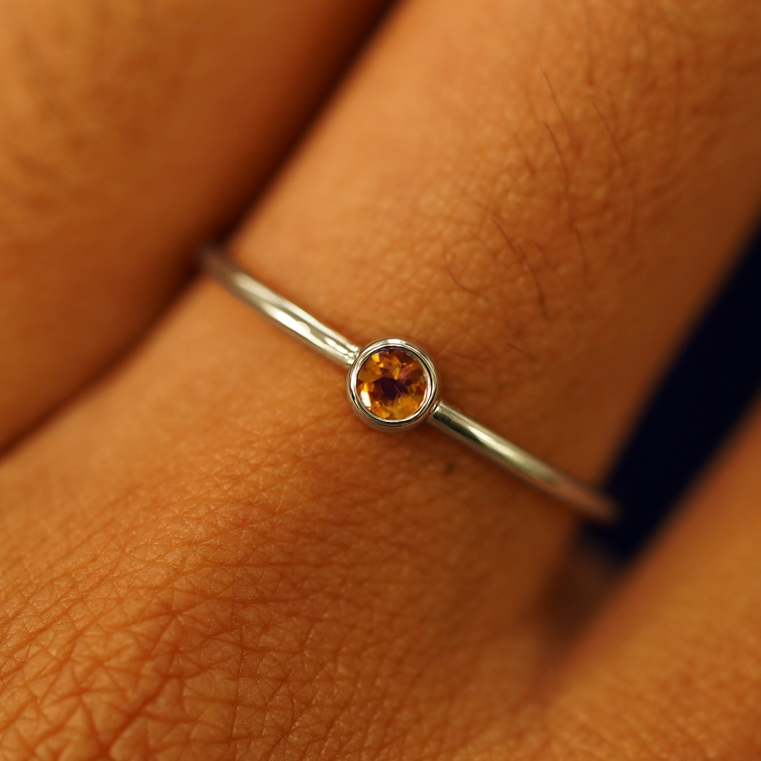 Close up view of a model's fingers wearing a 14k champagne gold Citrine Ring