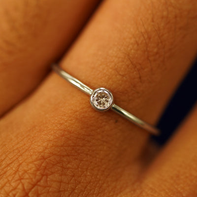 Close up view of a model's fingers wearing a 14k champagne gold Champagne Diamond Ring