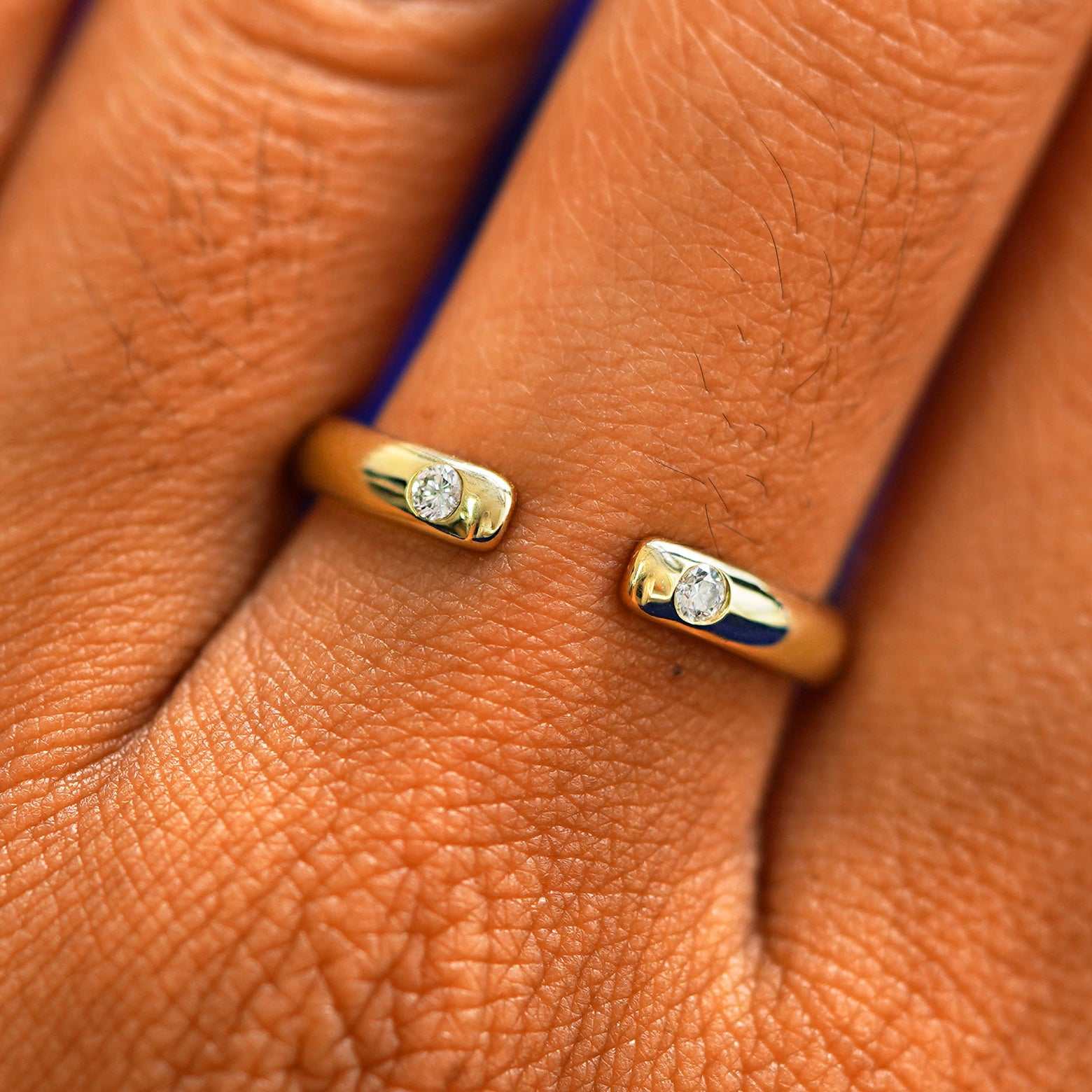 Close up view of a model's fingers wearing a 14k champagne gold Open Curvy Band