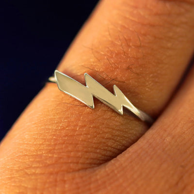 Close up view of a model's hand wearing a champagne gold Lightning Bolt Ring