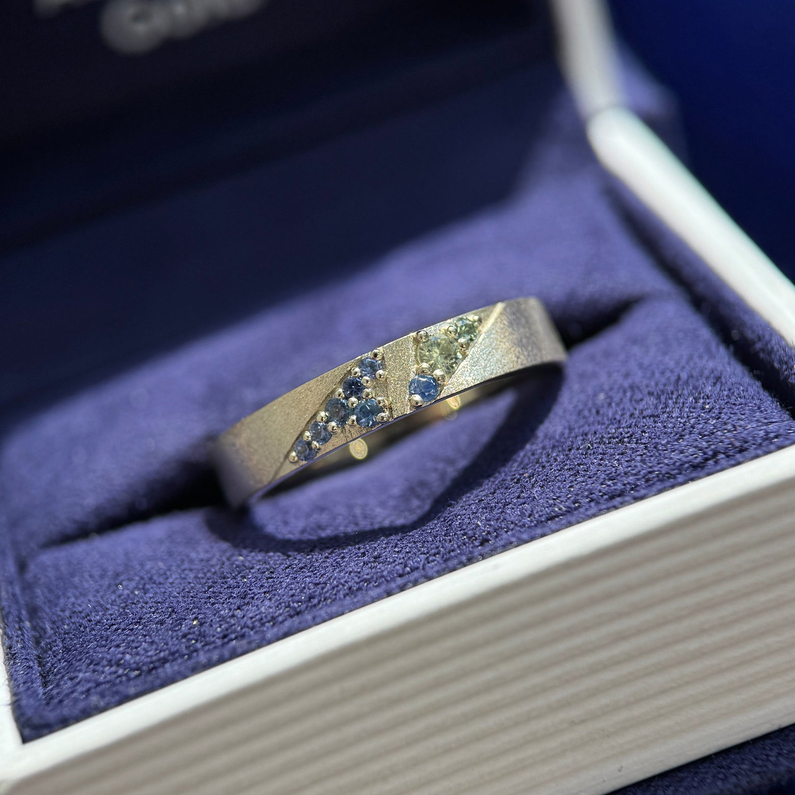 14k Nickel-free Champagne Gold and Triangle-set 9pc Green, Teal, Blue Sapphires on 4mm Industrial Stardust Band Custom Ring, size 7.5 