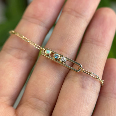 14k Yellow Gold Dancing Gemstone Bracelet With A Diamond, Blue Topaz, And Opal Length 7.25inch