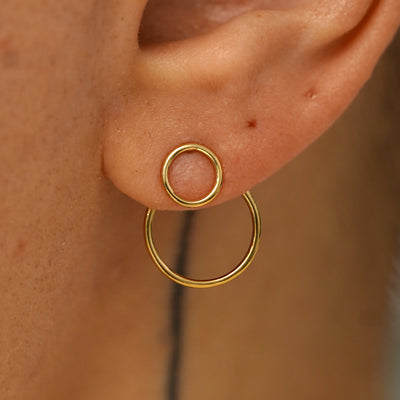 Close up view of a model's ear wearing a 14k yellow gold Open Circle Jacket with an Open Circle Earring