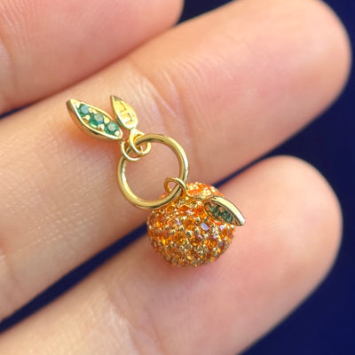 side view of 14k Yellow Gold 1.25mm Orange Sapphires Pave Clementine Custom Charm With Emeralds on the Leaves and with بابا engraving