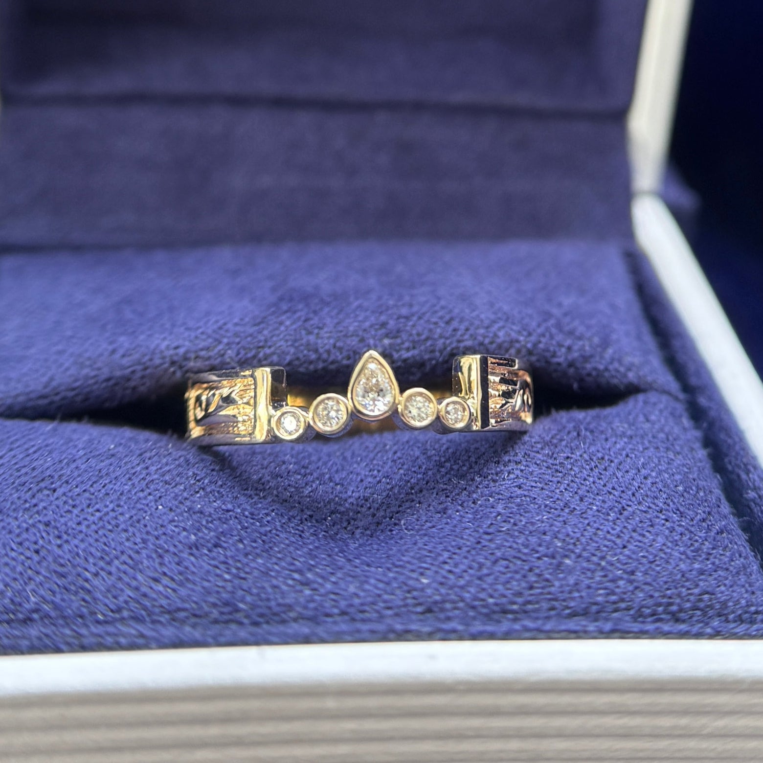 14k yellow gold and 0.11ct round and pear lad diamonds bezel set into customers band size 6.5 (polish off the height of the bars)