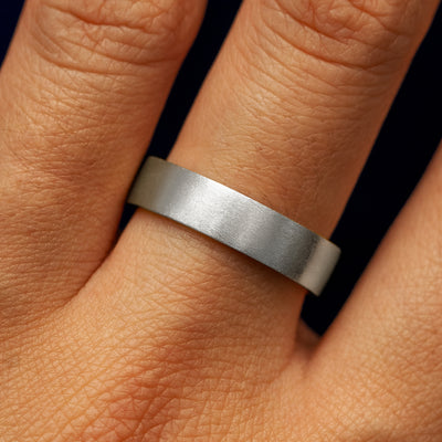Close up view of a model's fingers wearing a platinum Industrial Matte Band