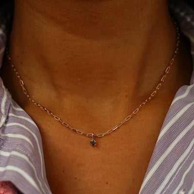 Close up view of a model's neck wearing a rose gold Black Diamond Charm on a Butch Chain