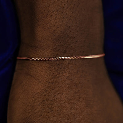 A model's wrist wearing a 14k rose gold Mini Miami Bracelet