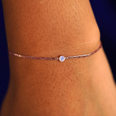 A model's wrist wearing a 14 karat rose gold Moonstone Bracelet