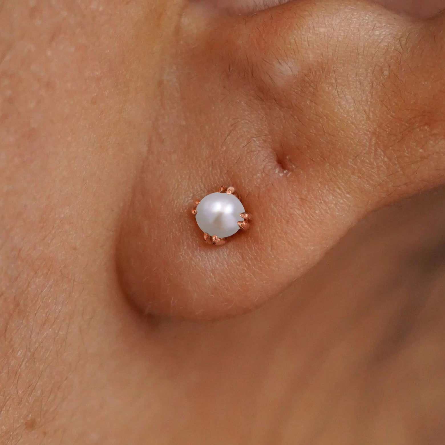 Close up view of a model's ear wearing a 14k rose gold Citrine Stud Earring
