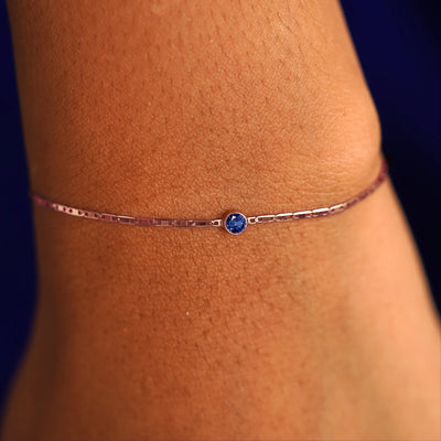 A model's wrist wearing a 14 karat rose gold Sapphire Bracelet