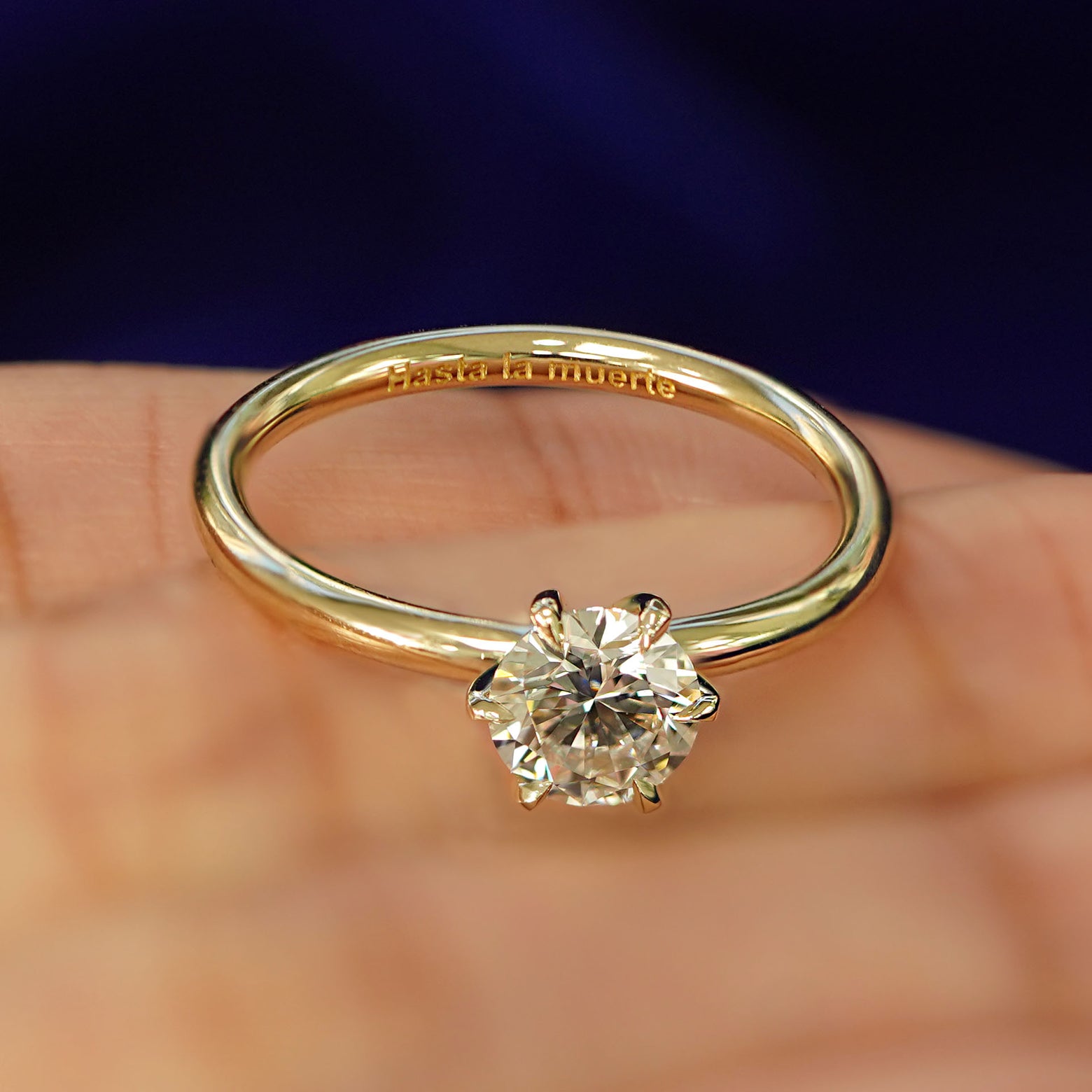 A 14k yellow gold Round Lab Diamond Ring with the words Hasta La Muerte engraved on the inside of the band