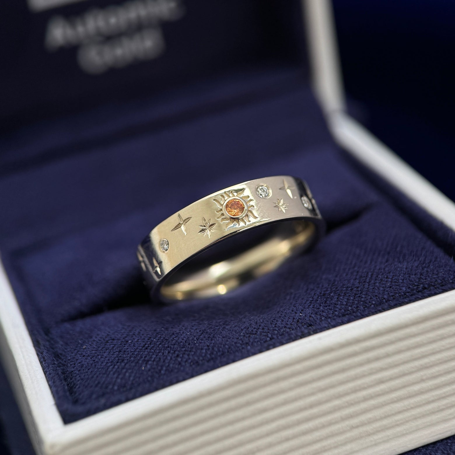 14k Champagne Gold and Round Orange Sapphire in a Sun with 3pc Round Moissanites and Engraved Stars on 5mm Industrial Mirror Band Custom Ring, size 6.5