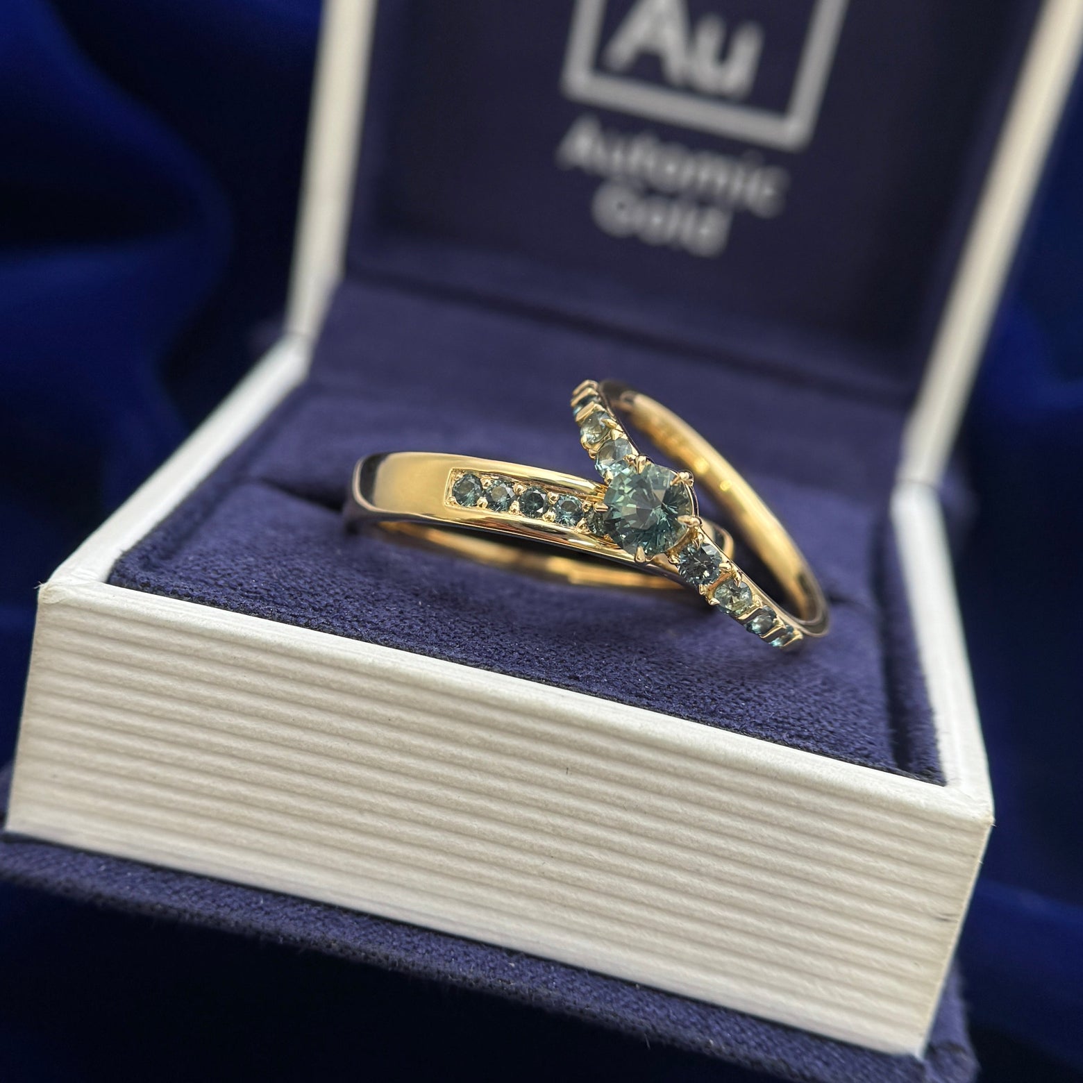 18k Yellow Gold Bead-prongs-set 5x2mm Round Teal Sapphires on 4mm Mix Mirror Band Custom Ring, size 10 and 18k Yellow Gold and 4mm Round Teal Sapphire with 8pc Graduating is size Teal Sapphires on Custom Ring, size 6