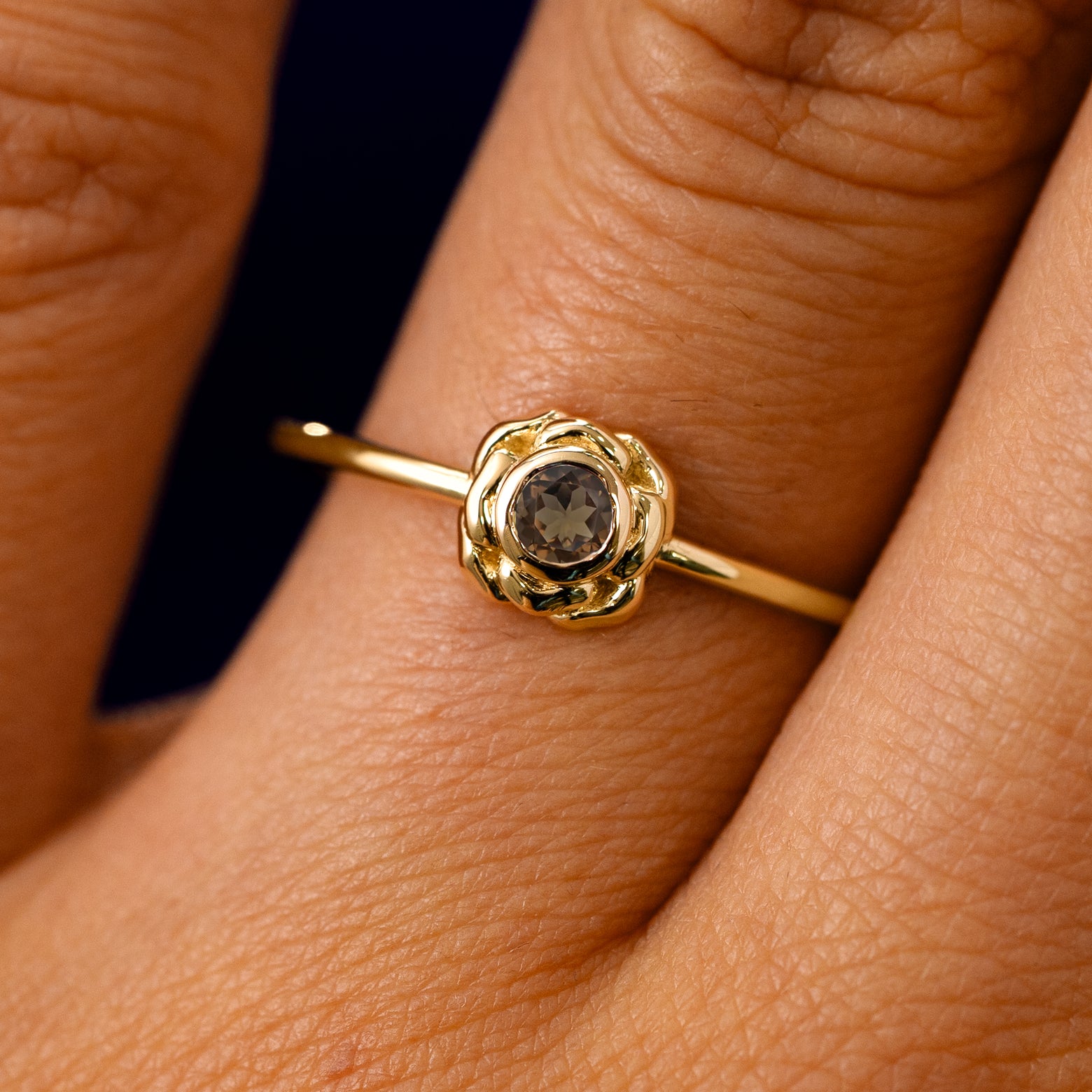 A solid 14k yellow gold Smoky Quartz Gemstone Flower Ring on a model's finger