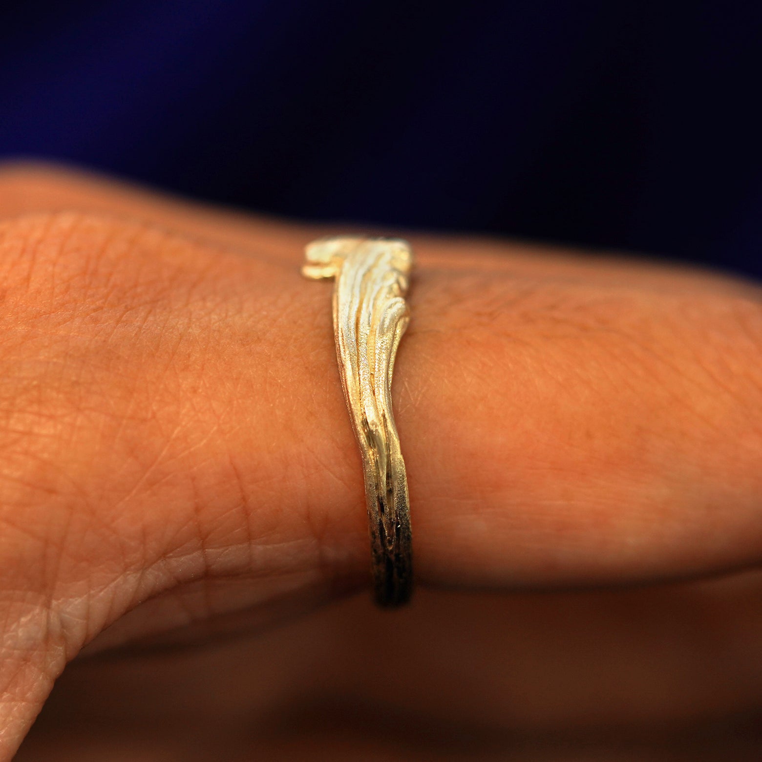Side view of a Crashing Waves Band on a model's finger to show details