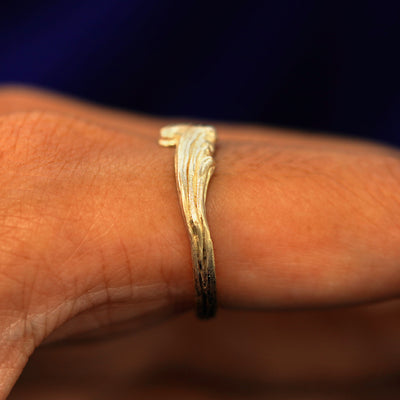 Side view of a Crashing Waves Band on a model's finger to show details