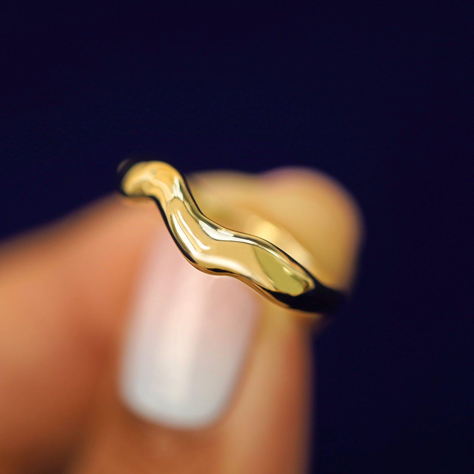 Alternate view of a model holding a Liquid Band tilted to show more unique waves in the band