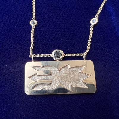 close up of necklace in with solid matching pendant