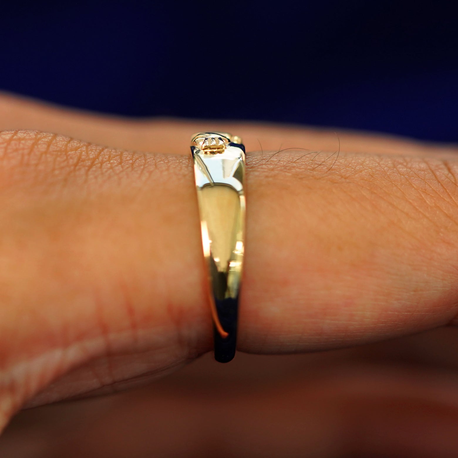 Side view of a  Claddagh Band on a model's finger