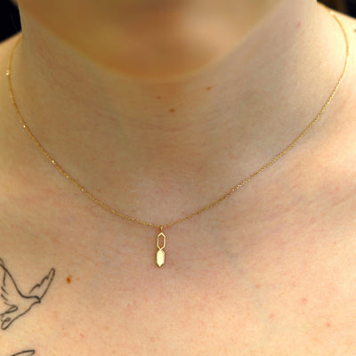 A model's neck wearing a yellow gold Tanlah Cable Necklace
