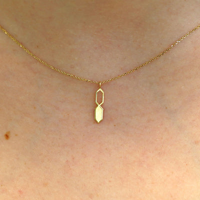 Close up view of a model's neck wearing a yellow gold Tanlah Cable Necklace