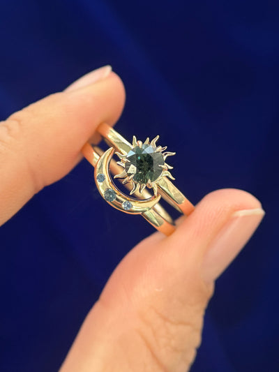 14k Yellow Gold and 2mm Teal Sapphire Flush-set into Sun on 2mm Mix Mirror Band Custom Nesting Ring, 3.5 grams, and 14k Yellow Gold and 3pc Small Teal Sapphires Flush-set into Moon on 2mm Mix Mirror Band Custom Nesting Ring, 3 grams both in size 8.25