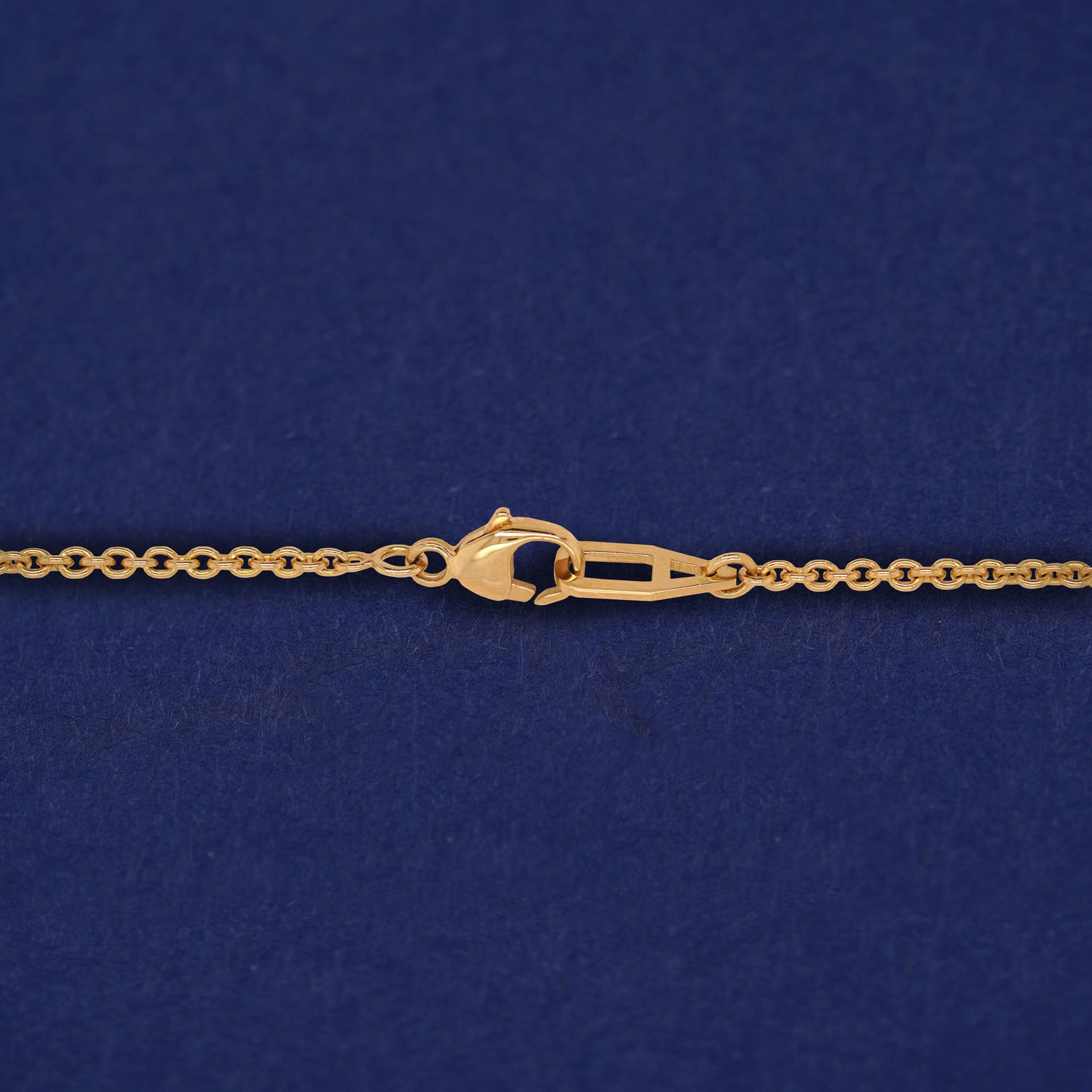 Close up view of a clasped AU lobster claw clasp on a Bound Together Necklace