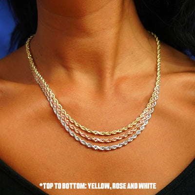 Close up view of a model's neck wearing three versions of the Thick Rope Chain in options of rose, yellow, and white gold