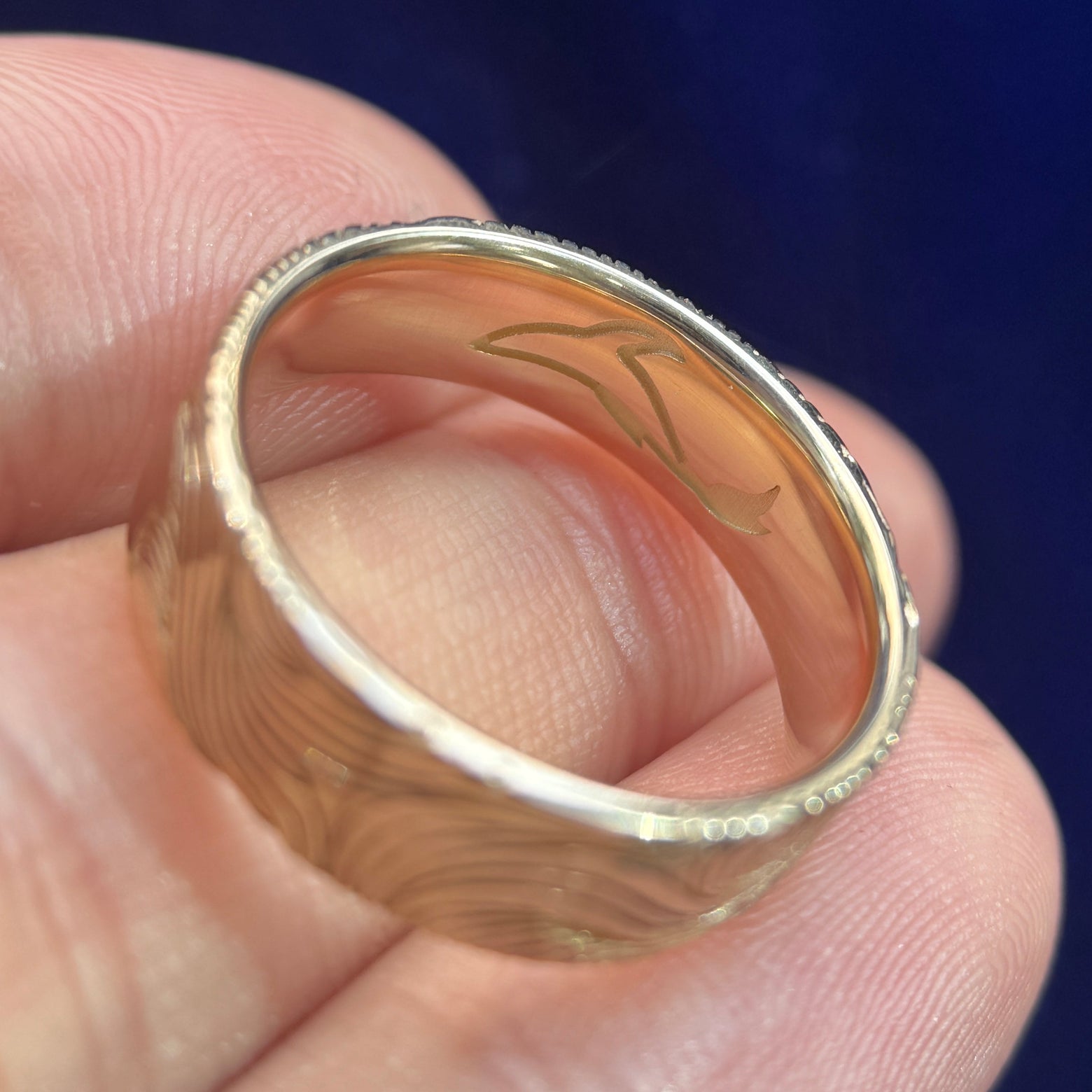 close-up of whale engraving inside of 14k Yellow Gold Unique Non-repeating Waves Engraved Outside and Whale Engraved on the inside of 6mm Industrial Comfort-fit Band Custom Ring, size 7