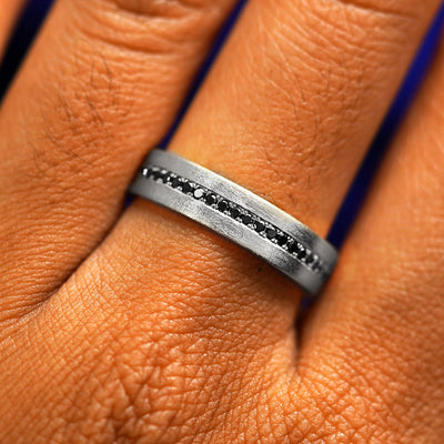 Close up view of a model's fingers wearing a 14k white gold Endless Diamond Band