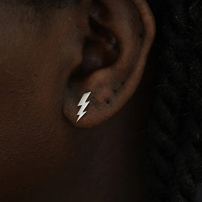 Close up view of a model's ear wearing a 14k white gold Lightning Bolt Earring