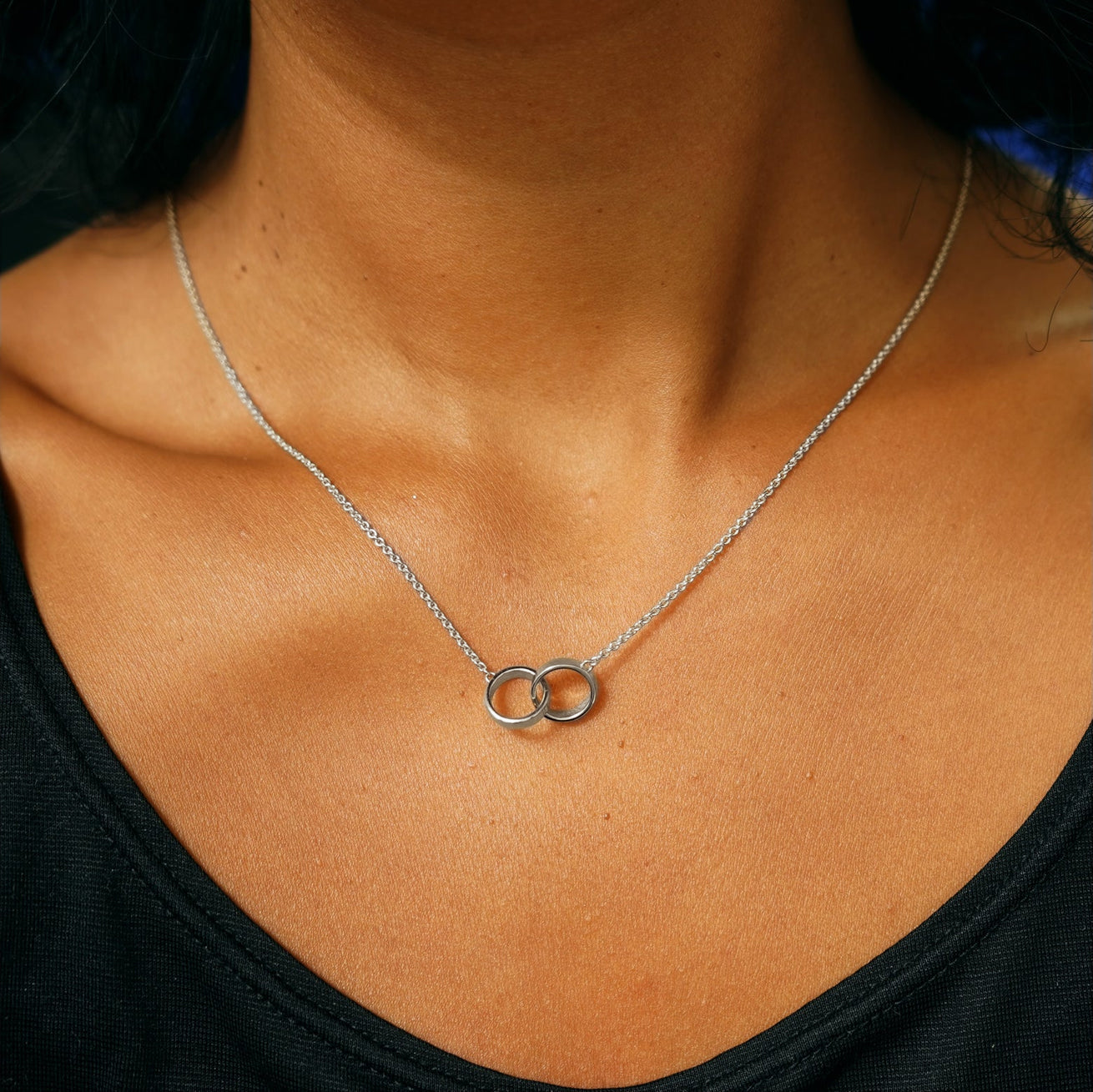 A model's neck wearing a white gold Bound Together Necklace
