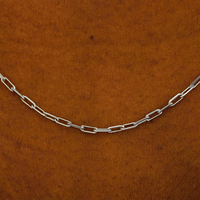 Close up view of a model in a white shirt wearing a white yellow gold Butch Chain