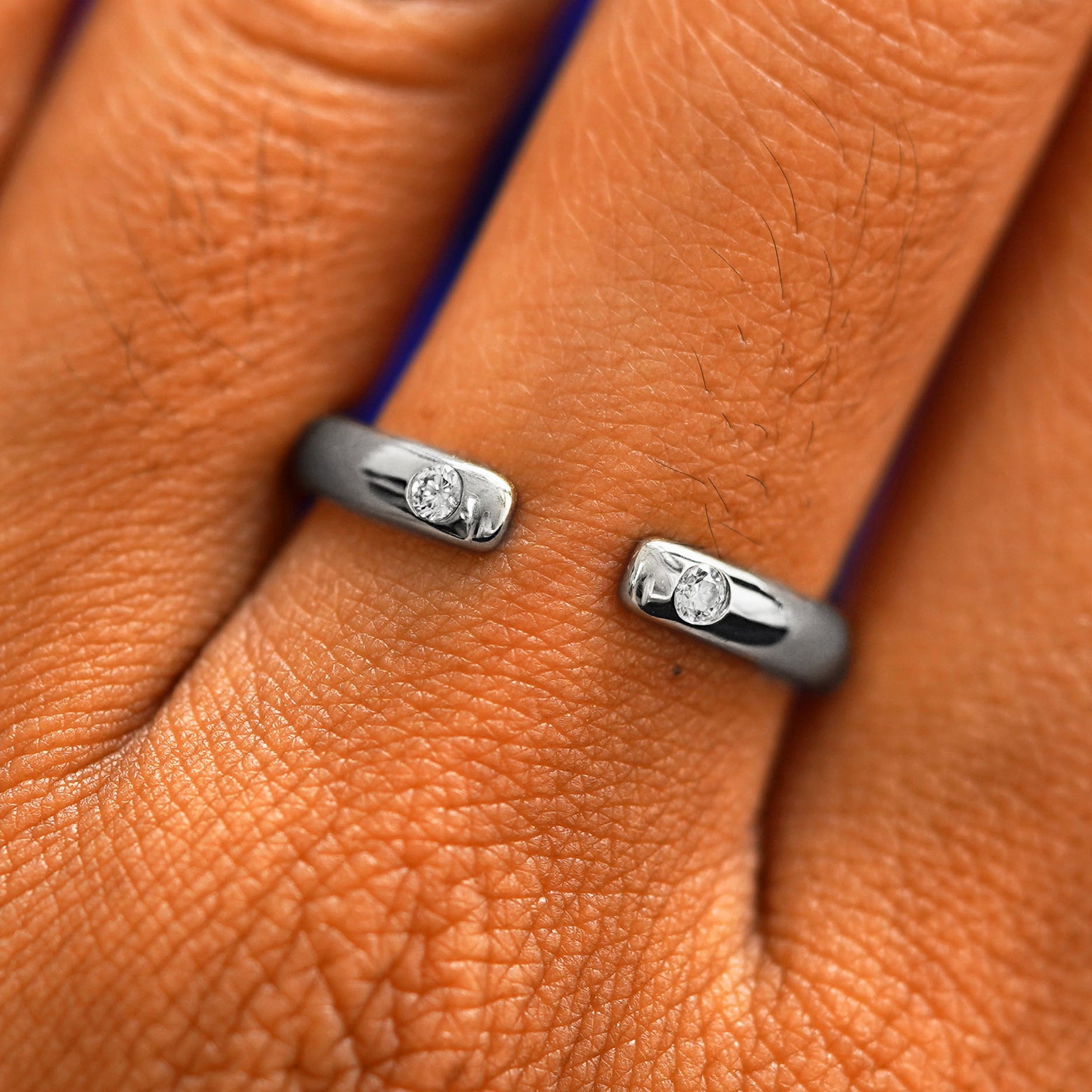 Close up view of a model's fingers wearing a 14k white gold Open Curvy Band