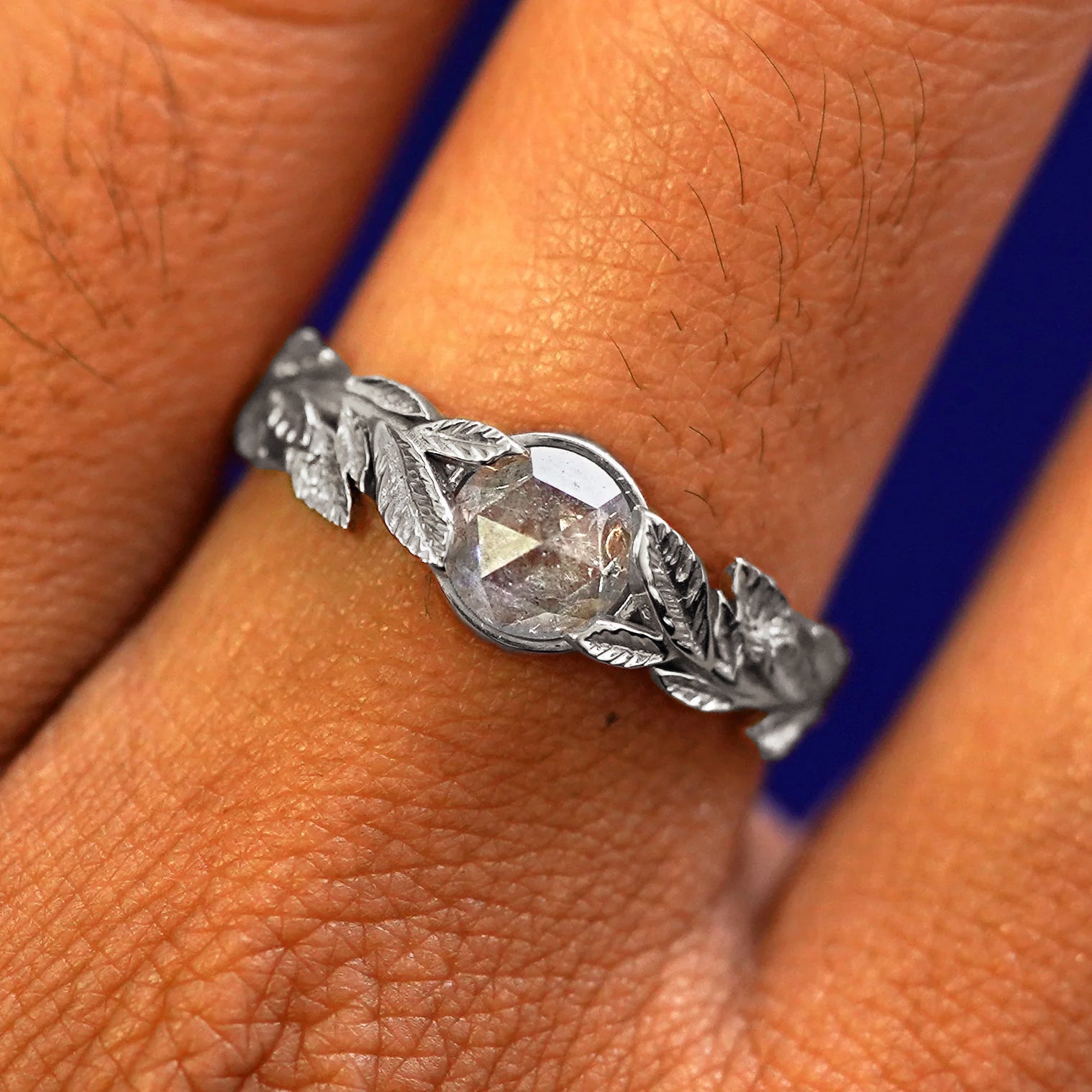 Close up view of a model's fingers wearing a 14k white gold Diamond Leaves Ring