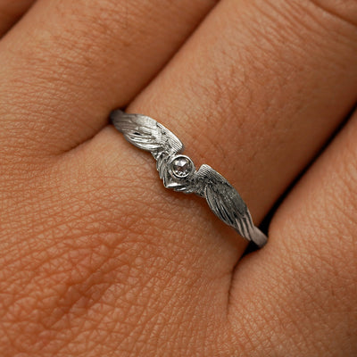 Close up view of a model's fingers wearing a 14k white gold Diamond Wings Ring